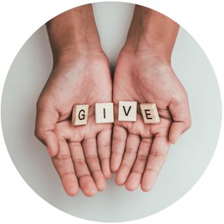 Image of open hands holding tiles that spell "G-I-V-E"
